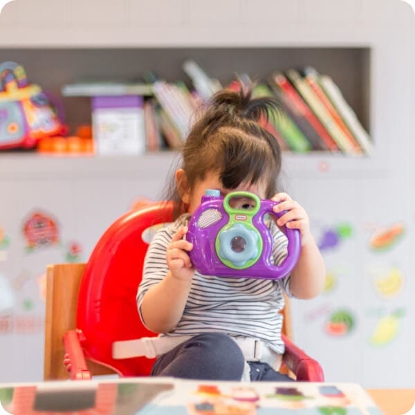 Child holding camera